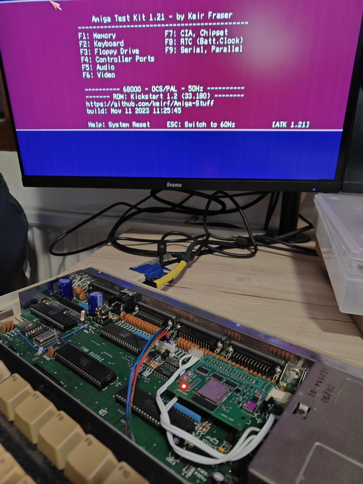 The open Amiga 500 with FluxDrive rev A inside and Amiga Test Kit 1.21 on the monitor